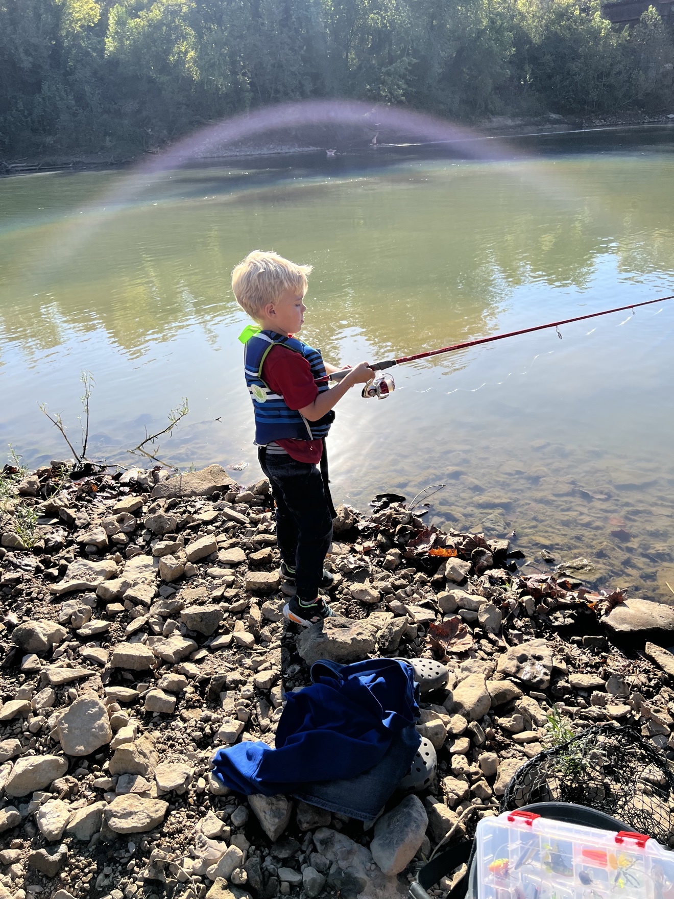 Kid fishing from the riverbank